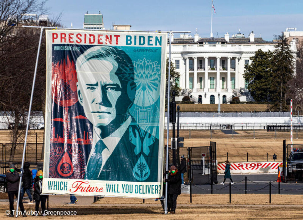 Larger picture of Biden in front of the White House that says 